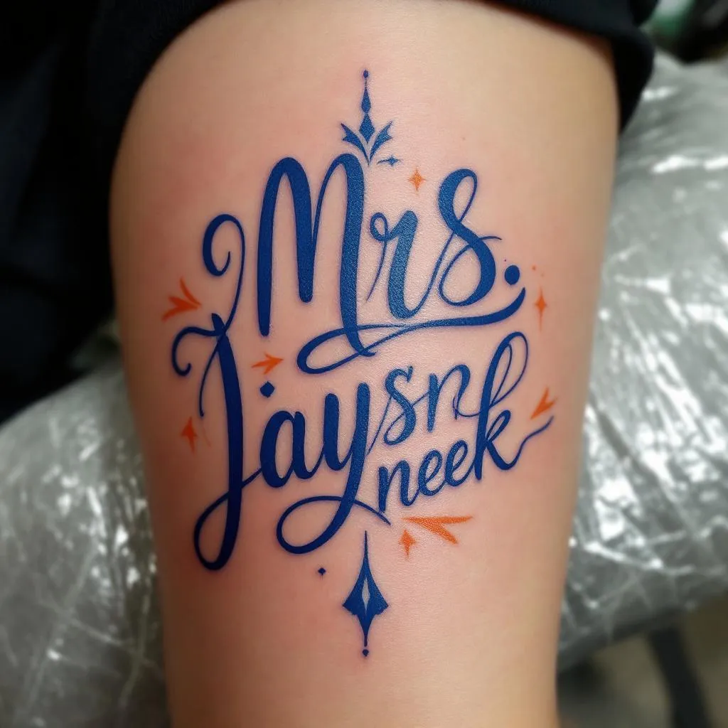 MRS.LADYJAYSNEEK

BOLD CURSIVE IN ROYAL BLUE WRITING WITH ORANGE ACCENTS SURROUNDING THE CURSIVE